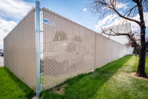 Commercial chain link fence with privacy slates