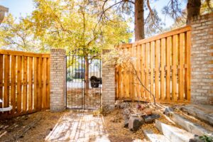 Iron and stone gate with cedar fence Littleton