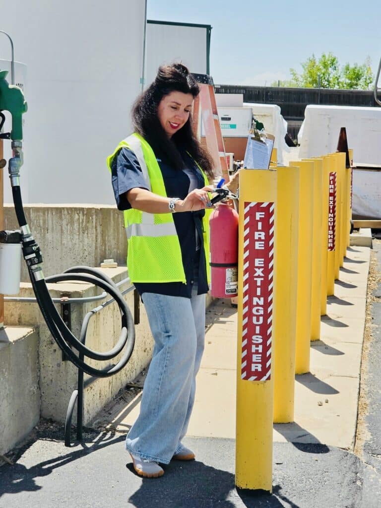 Christina, our OSHA safety officer checking a fire extinguisher